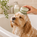 Silicone pet bath brush with shampoo dispenser during dog bath